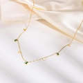 Detail of gold titanium necklace featuring green rectangular zircons and square charms - Green Zircon Square Necklace / Gold