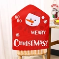 Detail of Christmas snowman chair cover with Ho Ho text in a cozy dining room setting - Snowman