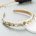 Detail of luxury bee headband with rhinestones, pearls and vintage gold floral accents - White