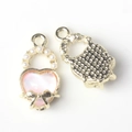 Close-up of pink heart charm with white pearl and golden bow knot for DIY jewelry - Gold Base Pink