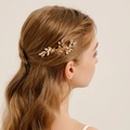 Golden bridal hair comb with alloy leaves, pearls, and rhinestones on a blonde model - 14# Gold Hair Comb