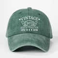Detail of Vintage 1973 printed text on washed forest green baseball cap fabric - One Size / Dark Green