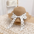 Detail of hand-woven straw hat with scalloped brim and polka dot bow on lace tablecloth - 52cm (2-5 Years) / Khaki Straw Hat