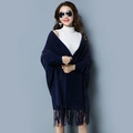 Close-up of navy blue knit poncho cape featuring delicate tassel fringe at the hem - Navy Blue