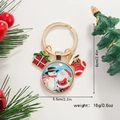 Vue détaillée du porte-clés de Noël avec dimensions 6cm par 5,5cm et poids de 16g - Père Noël et Bonhomme de Neige
