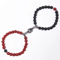Close-up of red and black stone beaded magnetic bracelets with hand-holding shaped clasp - Red Turquoise + Matte Stone Bracelet