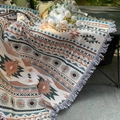 Detail of bohemian knit blanket with geometric patterns and fringe edges on a camping table - Bohemian Geometric Pattern / 130x160cm