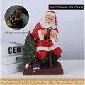 Christmas Santa resin figure with light-up tree holding list and magnifying glass - Santa Sitting On Chair With LED