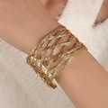 Macro detail of gold layered spiral cuff bracelet showing metallic woven texture - Gold Woven Hollow Cuff Bracelet