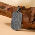 Dark metal dog tag necklace with US flag pattern and engraved letter R on wood - Letter R Necklace