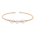 Macro detail of gold-plated open bangle featuring three large white freshwater pearls - Triple Large White Pearl Style (ZZ-0014)