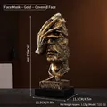 Modern abstract face sculpture in gold finish with hand covering half face and black base - See No Evil (7111-21) / Antique Bronze