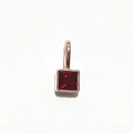 Square cut deep red gemstone pendant in rose gold setting on white background - Rose Gold January