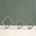 Grey floating jewelry display case set with frames and bases in three different sizes - Gray