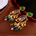 Macro shot of vintage baroque gold branch earrings with green gemstones and blue crystals - Green Resin Rhinestone Branch Dangle Earrings (Silver Needle)