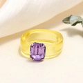 Close-up of a wide yellow resin ring featuring a purple octagon-cut crystal accent - One Size / Yellow