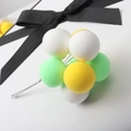 Detail view of colorful clay balloon cake toppers in white, yellow and green on wire stems - Ball Bundle / Yellow Green White Ball Bundle
