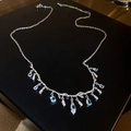 Irregular geometric branch necklace in silver with light blue teardrop stones and crystals - Water Drop Necklace