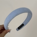 Detailed view of the soft blue terry cloth texture and handmade label on the headband - Headband / Blue