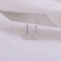 Macro shot of silver leaf earrings showing detailed veins on white fabric background - White Gold