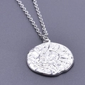 Macro shot of silver sun and moon embossed pendant with hammered metal texture - Silver Necklace