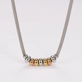 Detail of cable link necklace with tricolor silver, gold, and rose gold beads - Necklace