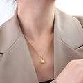 Minimalist 18k gold plated lock pendant necklace worn on model with chic office attire - Style A - Protruding Lock / Gold