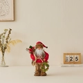 Babbo Natale in piedi con maglione rosso a maglia che tiene corona e sacco regali - 30cm