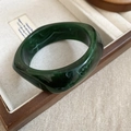 Detailed view of dark green marble resin bangle on a wooden tray with linen lining - Dark Green Marble Pattern