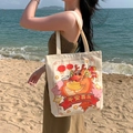 Beige canvas tote bag with cartoon dragon print and character Ping An Xi Le on beach - Auspicious Dragon Year