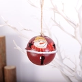 Red metal Christmas bell with snowman pattern and star cutouts on rustic wood - Snowman / Red