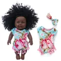 African baby doll with curly hair wearing a blue floral romper and matching headband - 30cm Black Doll / Big Floral Pompom Romper Tie-Dye