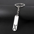 Minimalist silver metal keychain featuring a hollow capital letter X pendant on black background - Letter X