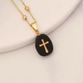 Elegant gold chain necklace with a black stone pebble pendant and gold cross accent - Agate