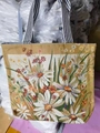 Vintage canvas tote bag featuring vibrant daisy floral embroidery and striped handles - Green Grass