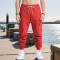 Outdoor shot of red heavy cargo pants with drawstring waist and multi-pocket design for men - S / Red