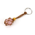 Detail of a pink quartz stone secured in a brown braided rope pouch keychain - Brown Rope + Rose Quartz