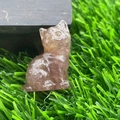 1.2 inch hand-carved pink crystal cat figurine sitting on green grass - Strawberry Quartz