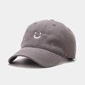 Close-up of white smiley face embroidery on a grey cotton twill baseball cap fabric - Adjustable / Gray