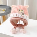 Close-up of pink knit earflap hat for kids with bunny patch and furry trim details - 2-8 Years / Pink