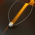 Detailed close-up of a silver titanium star necklace with colorful zircon stones on leather - Silver