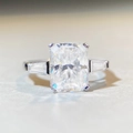 Macro shot of 4 carat emerald cut moissanite ring in S925 sterling silver three-stone design - US 5 / Radiant Cut Three Stone 4ct-Silver