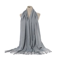 Close-up of gray cashmere scarf with tassel details and material label on mannequin - Light Gray