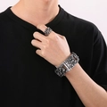 Punk style silver skull ring and cuban chain bracelet set on model hand - Bracelet + Size 9 Ring