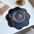 Elegant black petal-shaped PVC leather placemat with embossed edges on white table - Flower / Black