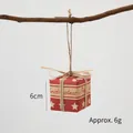 Mini red Christmas gift box ornament with white stars and twine bow on a branch - Letter & Star