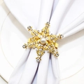 Elegant gold snowflake napkin ring with rhinestones and pearl on white fabric - Gold Snowflake Style 131