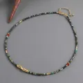 Bohemian handmade turquoise beaded necklace with gold dragon pendant and red accents - Ethnic Pixiu Pendant