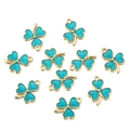 Detail of ten gold-edged green enamel clover charms with fine radial texture - Teal