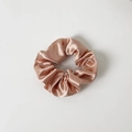 Close-up of champagne silk satin scrunchie with elegant pleated texture and soft luster - Without Card / Rose Gold